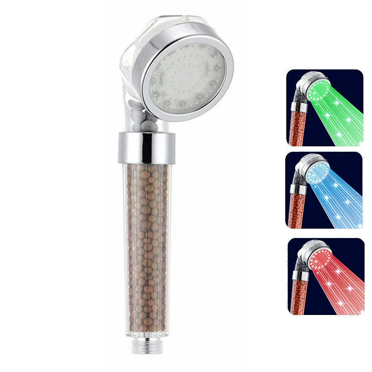 Smoovea shower head showing the transparent mineral-bead chamber and LED ring color options