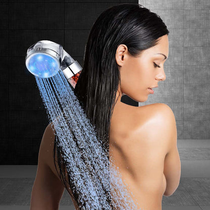 Close-up of the Smoovea shower head's spray plate and LED ring in each of its three colors
